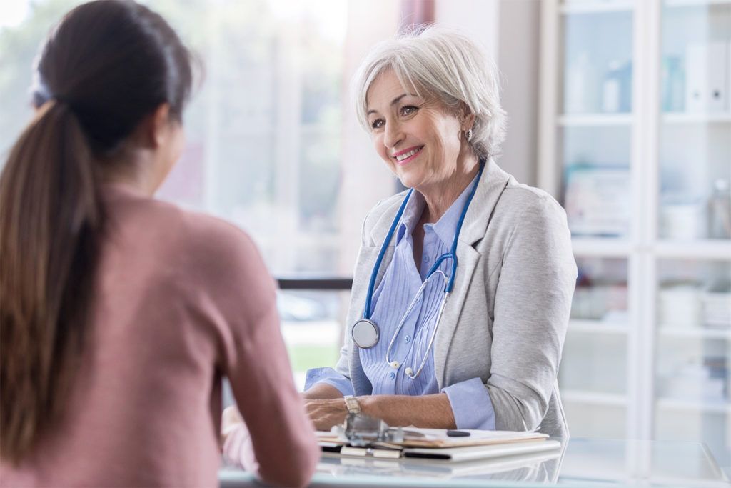 Female doctor meets with female patient